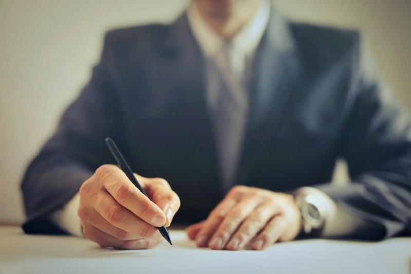 A man signing a contract